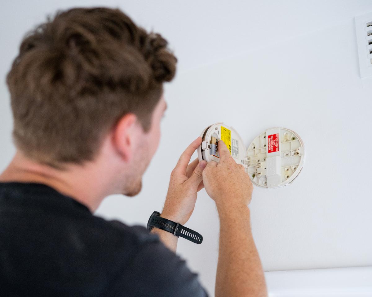 Electricians Near You electrician replacing a hardwired smoke alarm